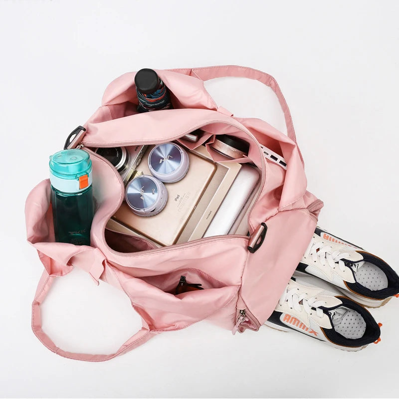 Women's gym shoulder bag interior compartments and storage pockets detail